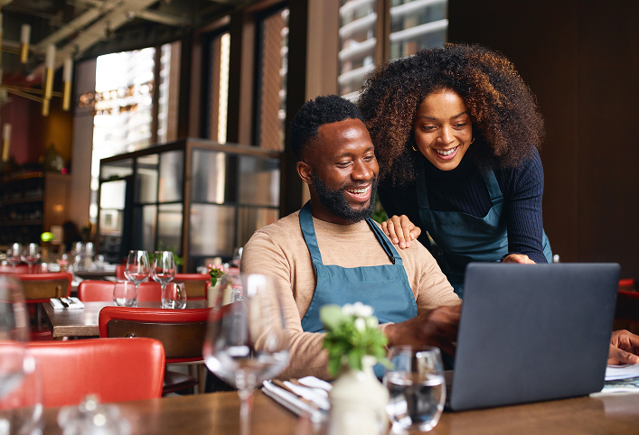 Business owners looking over laptop